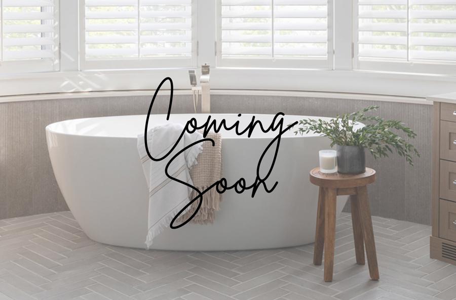 Bright modern bathroom with a freestanding tub, plantation shutters, and herringbone tile flooring, designed by a top Interior Design Calgary team.