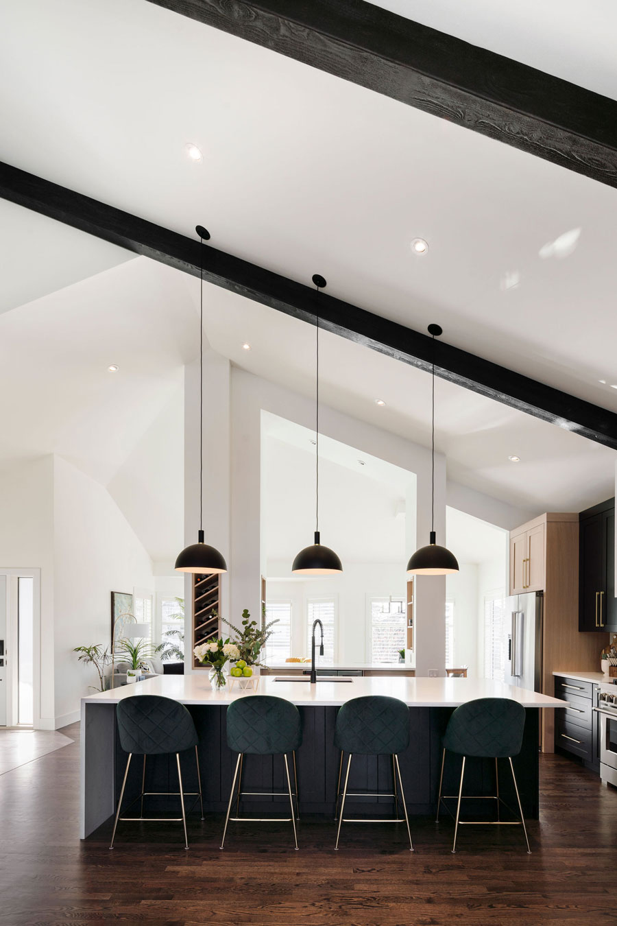 Modern kitchen interior design featuring a central island with bar stools and elegant pendant lighting, designed by the best Interior Designer in Calgary.
