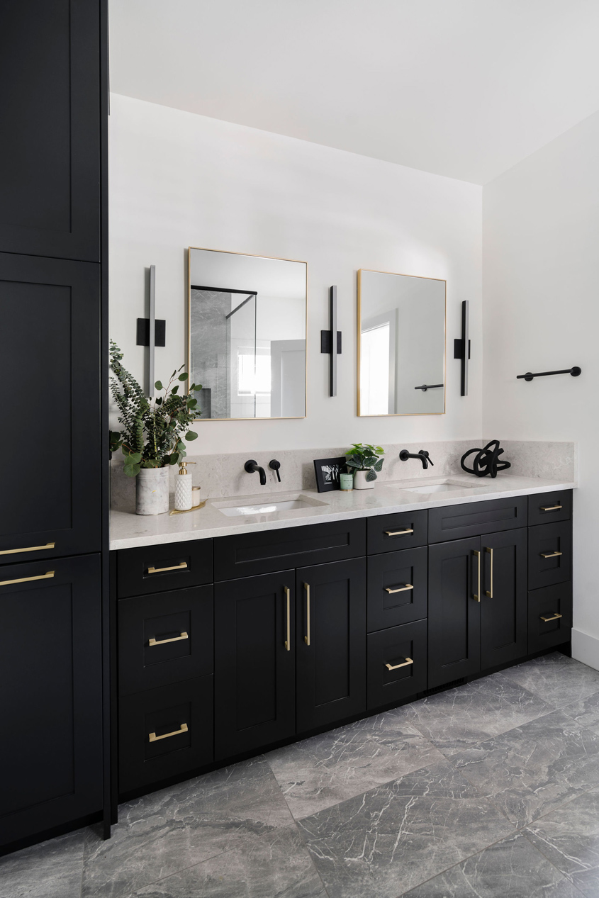Modern bathroom renovation with black vanity and white counters, designed by a top Calgary interior designer.