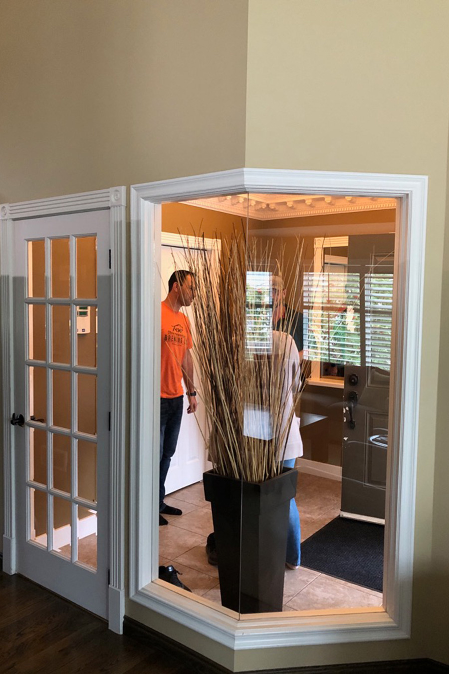 The Before Photos: A beautiful transformation of a home in Signal Hill, looking at the old foyer, with the new space designed by top Calgary Interior Designer