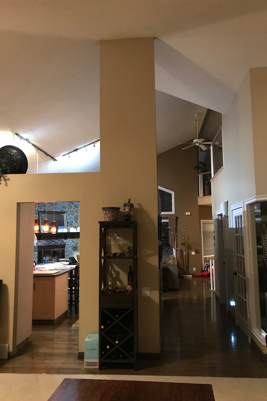 The Before Photos: A beautiful transformation of a fireplace remodel with grey marble tile and a sleek black fireplace, designed by top Calgary Interior Designer
