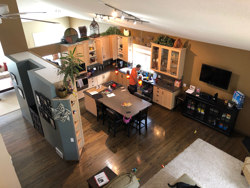 A before photo of a cluttered kitchen with awkward structure before it was redesigned into a beautiful modern kitchen by top Calgary Interior Designer