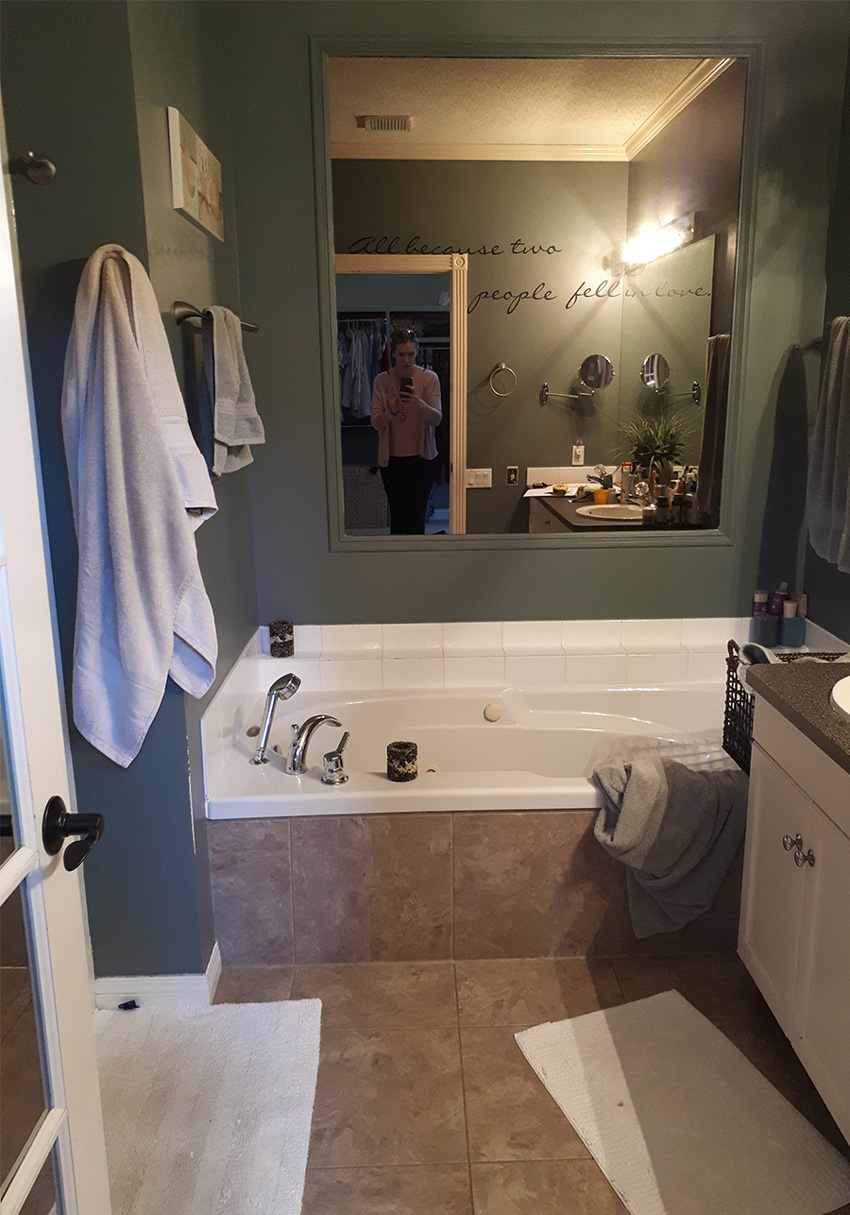 A before photo of a dark and dingy bathroom before it was redesigned into a beautiful modern kitchen by top Calgary Interior Designer