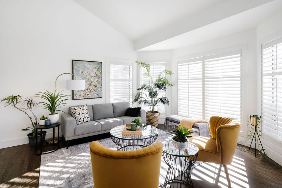 Bright living room with modern decor and ample natural light, featuring Calgary Interior Design.